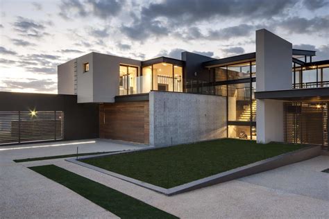 Geometric Concrete And Steel Home With Stone And Water Elements