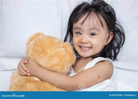 Asian Little Chinese Girl Hugging A Teddy Bear Stock Photo Image Of