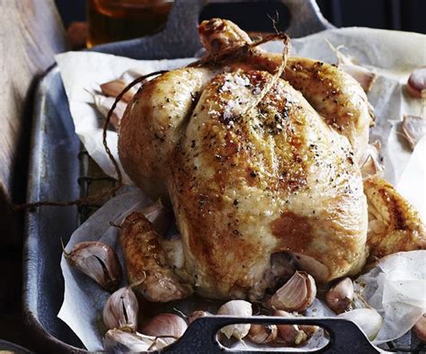Place the rosemary, thyme and lemon quarters in the cavity. Roast chicken with 40 cloves of garlic | Australian Women's Weekly Food