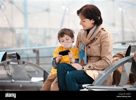 Loving Mother And Son Using Smartphone Stock Photo Alamy