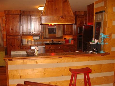 Flushmount lights are the most common ceiling lighting fixtures in most homes. Log cabin themed kitchen with bar and overhead light ...