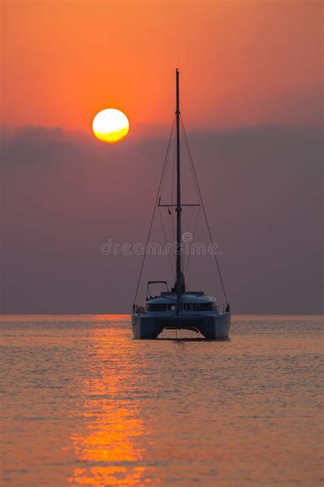 Sailing Catamaran On A Background Of A Beautiful Sunset In The Sea
