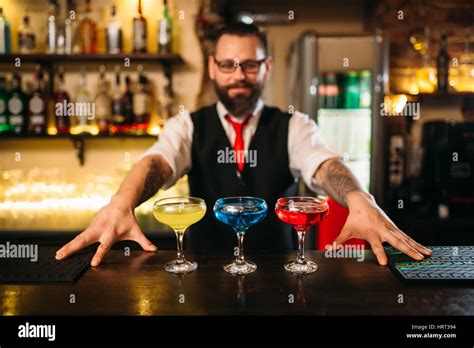 Bartender Behind Bar Counter Show Alcohol Coctails In Restaurant Stock