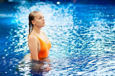 premium photo expressive beautiful woman posing in the swimming pool