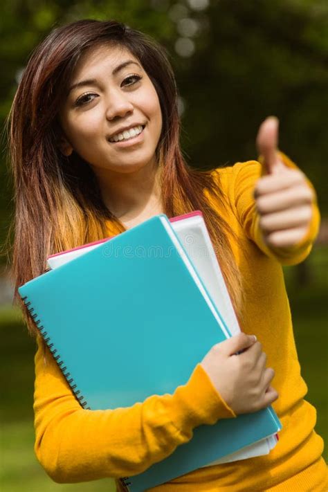 Female College Student Books Gesturing Thumbs Up Park Stock Photos
