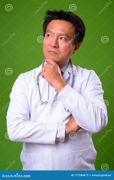Mature Japanese Man Doctor Against Green Background Stock Image Image
