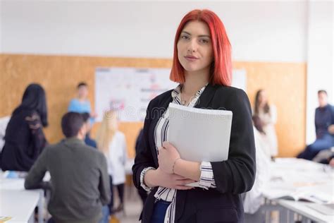 Female Redhead Professor Holding Lecture To Multi Ethnic Group Of