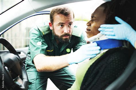 Paramedic Placing A Cervical Collar To An Injured Woman From Car