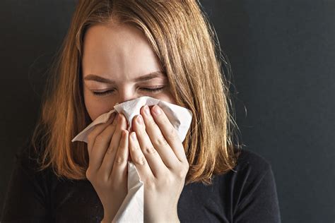 Sick Young Woman With Wrinkled Nose Blowing Her Nose And Fever St