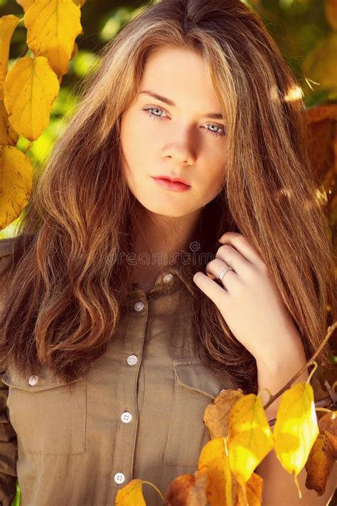 Beautiful Model With Autumn Leaves And Fall Yellow Garden Backgr Stock