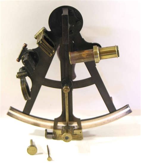 an antique nautical octant with an “a frame” in its original mahogany case with a accessories