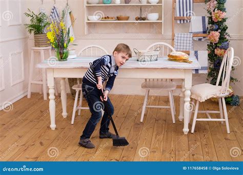 Little Boy Sweeping The Floor Pretty Boy Cleaning The Kitchen W Stock