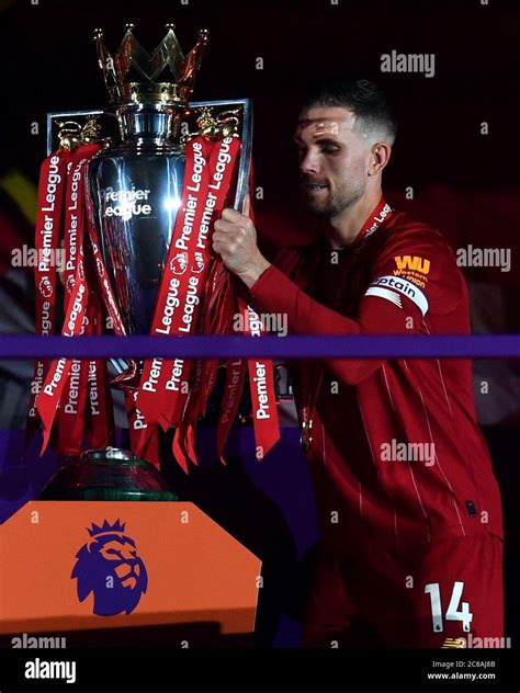 Liverpool Captain Jordan Henderson Lifts The Premier League Trophy