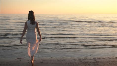 Back View Of Young Woman Walking On Water Stock Footage Videohive