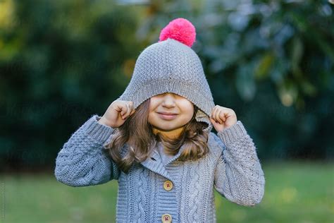 Portrait Of A Cute Young Girl Pulling A Hood Over Her Face By Stocksy Contributor Jakob