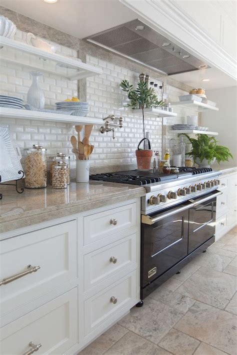 White shaker style kitchen cabinets are often paired with unornamented hardware to complement their simplicity. Stunning kitchen features white shaker cabinets paired ...