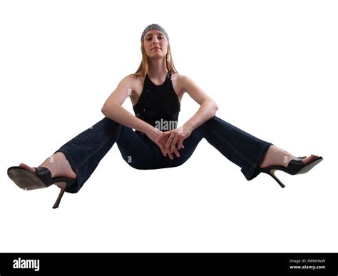 Young Caucasian Woman Sitting With Legs Apart In Jeans And Heels Stock