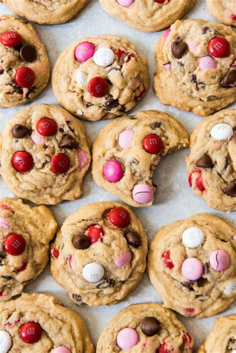 Line two large baking sheets with parchment paper or a silicone baking mat, and set aside. Pink, red, and white M&M candies turn chocolate chip ...