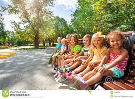 Cute Kids On The Bench In Park Toggether Stock Photo  
