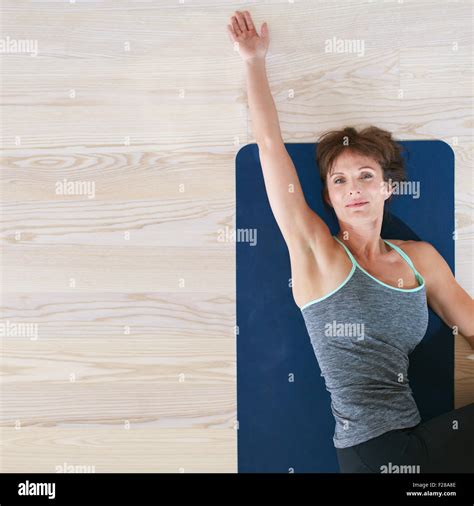 Top View Of Woman Lying And Stretching On Exercise Mat Female On Floor