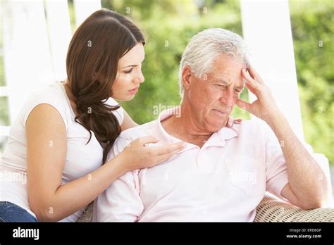 Adult Daughter Talking To Depressed Senior Father Stock Photo Alamy