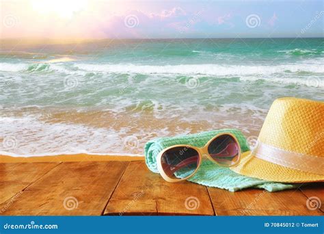 Fedora Hat And Sunglasses Over Wooden Table And Sea Stock Photo Image