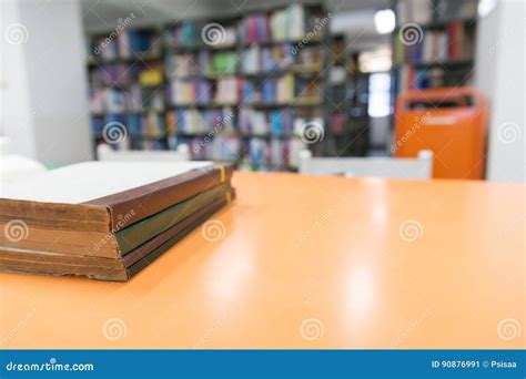 A Stack Of Old Books On Table With Blur Book In Library Education