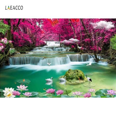 The Waterfall Is Surrounded By Pink Flowers And Water Lilies While