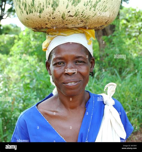 Woman Carrying Basin On Her Head Stock Photo Alamy