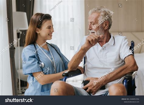 Young Asian Nurse Helping Senior Man Stock Photo 2169453741 Shutterstock
