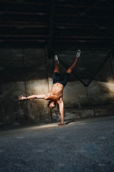 Fit Man Doing One Armed Handstand High Quality Sports Stock Photos