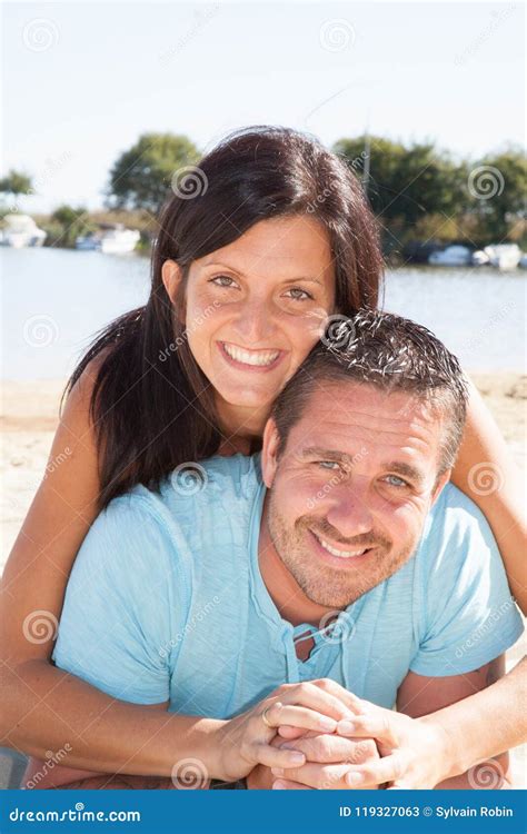 A Portrait Of Lying Young Couple At The Beach Stock Image Image Of