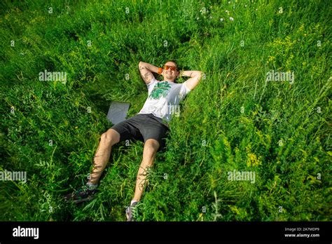 Man Lying Down On Grass With Laptop Top View Stock Photo Alamy