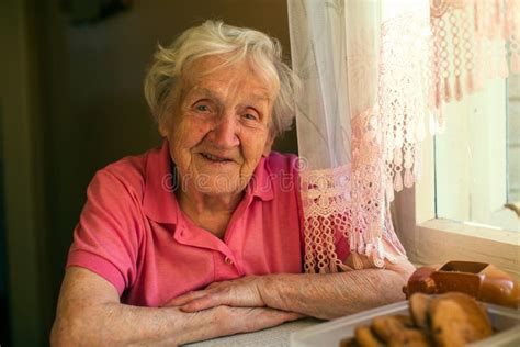 Close Up Portrait Of An Elderly Happy Woman In Her Home Stock Image