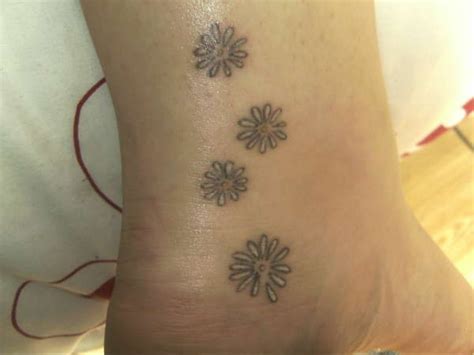 Daisy tattoo designs are great choices for tattoos for women! Delicate daisy chain tattoo on Maddy. Dot shaded and thin ...