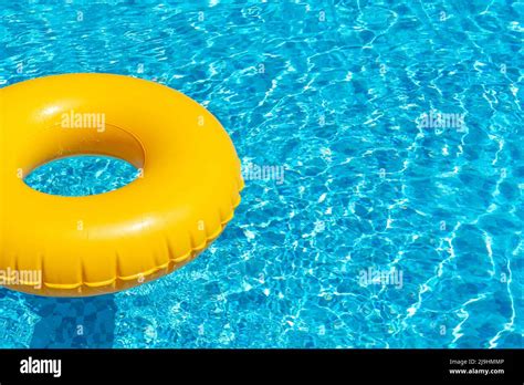 Yellow Ring Floating In Refreshing Blue Swimming Pool Stock Photo Alamy