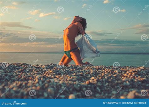 sensual girl with body relax on beach girl with naked chest sit on sand in sunlight stock