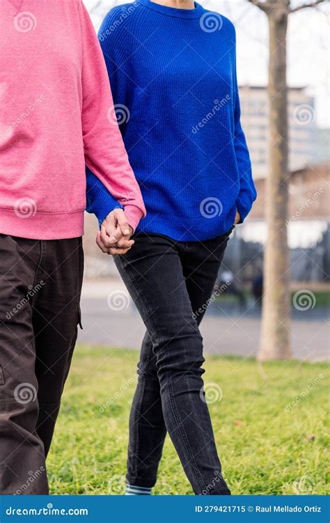 Two People Walking Together Holding Hands Stock Image Image Of