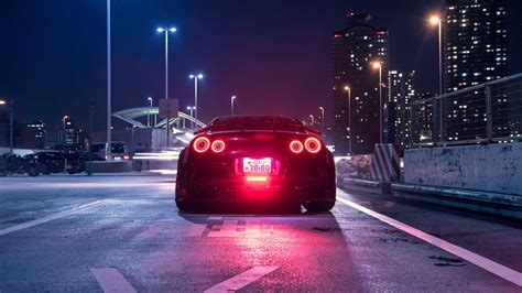 He runs a 21″ front wheel and a 15″ rear car tire. Wallpaper : Nissan GT R, Japanese cars, JDM, night, city, car, vehicle, rear view, street light ...