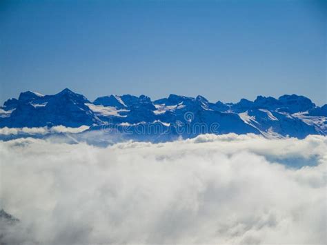 Amazing Aerial View Of Misty Swiss Alps And Clouds Above The Mountain