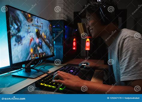 Portrait Of Smiling Asian Gamer Boy 16 18 Playing Video Games On Stock