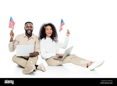 Happy African American Couple Holding Small Flags Of Usa While Sitting