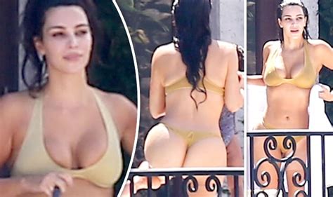 Kim kardashian flaunts famous derrière and ample cleavage in eye