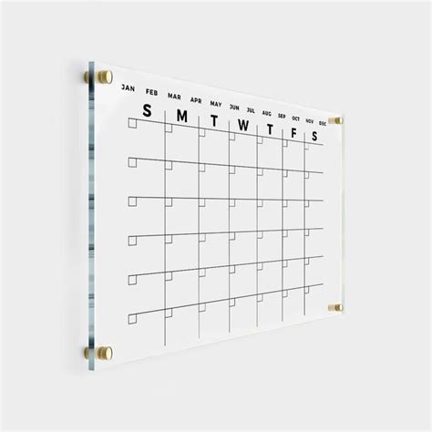 A White Wall Calendar Hanging On The Wall