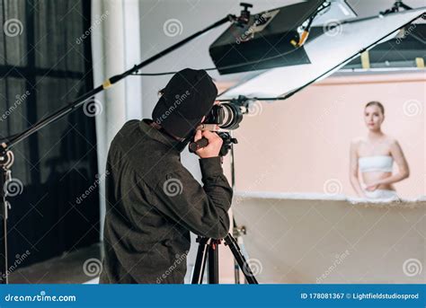 Selective Focus Of Cameraman Working With Beautiful Model Stock Image