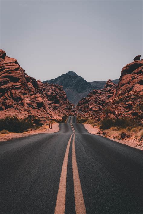 A Highway Road Through Rocky Cliffs At Valley Of Fire State Park
