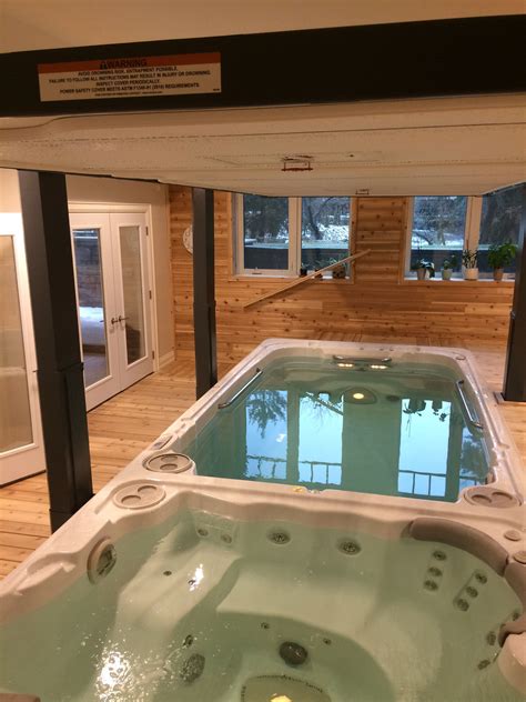Many municipalities will not allow you to install a swim spa in a spot with electrical mains running overhead. A beautiful indoor swim spa install, complete with ...