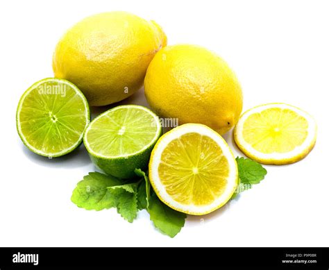 Two Whole And Sliced Yellow Lemon With Lime Halves Isolated On White