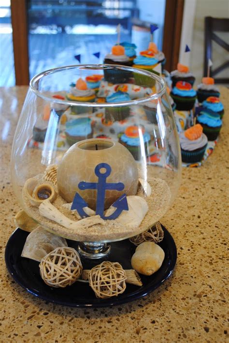 A Bowl Filled With Cupcakes Sitting On Top Of A Counter Next To An Anchor