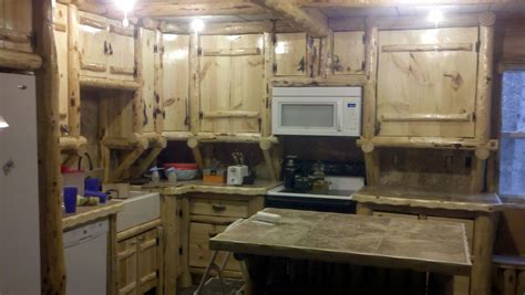 At times raw and weathered, and at others softly distressed, this warm and relaxed design style brings the charm of the outside in. Handmade Rustic Log Kitchen Cabinets And Bar by Drew's Up ...